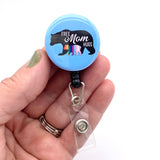 mom hugs bear badge reel